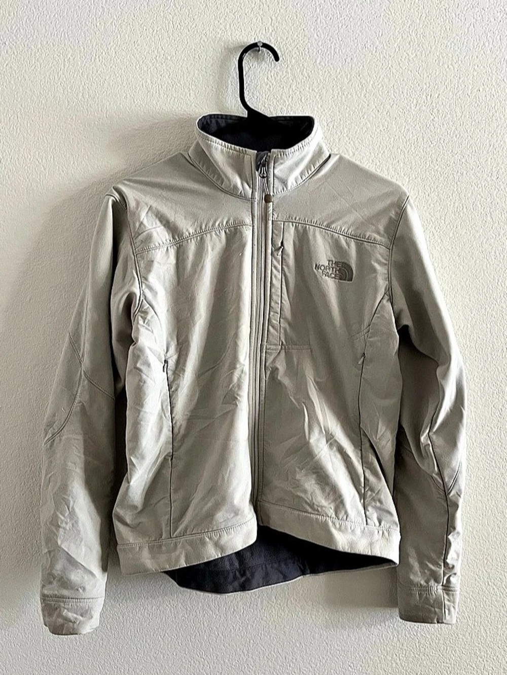 Beige women’s North Face puffer jacket